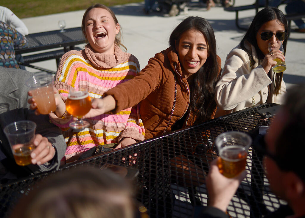 Natalie Rodriguez, center, shares a celebratory drink
